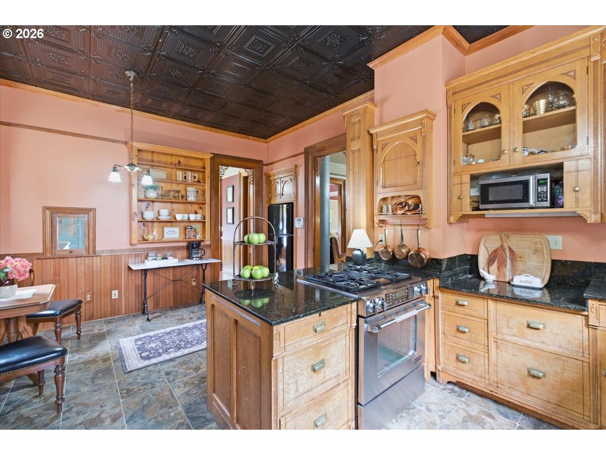 1121 Main Street Dallas, OR 97338 - Photo 20 of 48 a kitchen with stainless steel appliances granite countertop a stove and cabinets