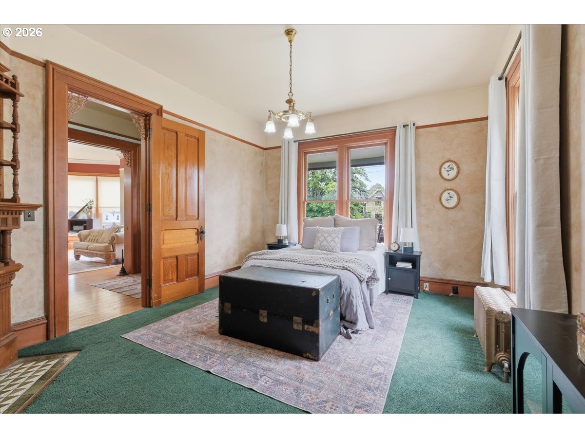1121 Main Street Dallas, OR 97338 - Photo 23 of 48 a spacious bedroom with a bed table and a flat screen tv