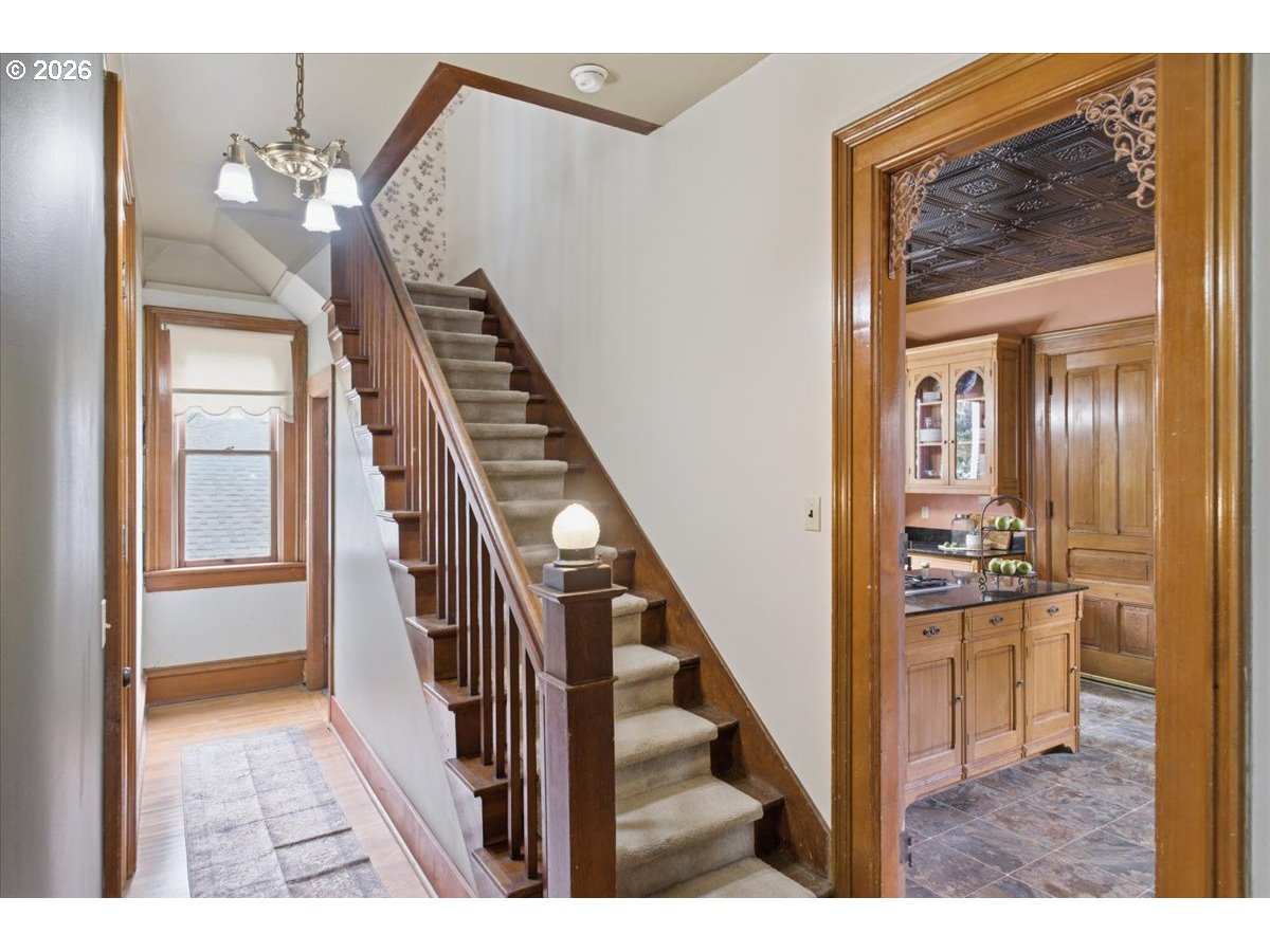 1121 Main Street Dallas, OR 97338 - Photo 27 of 48 a view of a hallway with wooden floor and staircase