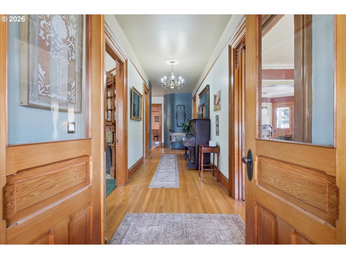 1121 Main Street Dallas, OR 97338 - Photo 8 of 48 a view of a hallway with wooden floor and furniture
