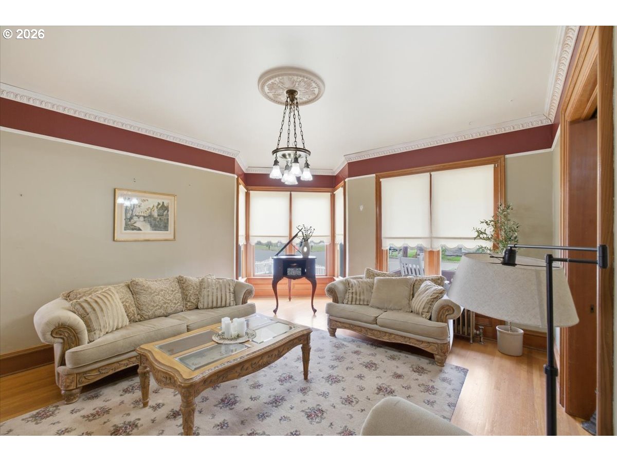1121 Main Street Dallas, OR 97338 - Photo 10 of 48 a living room with furniture a table and a chandelier