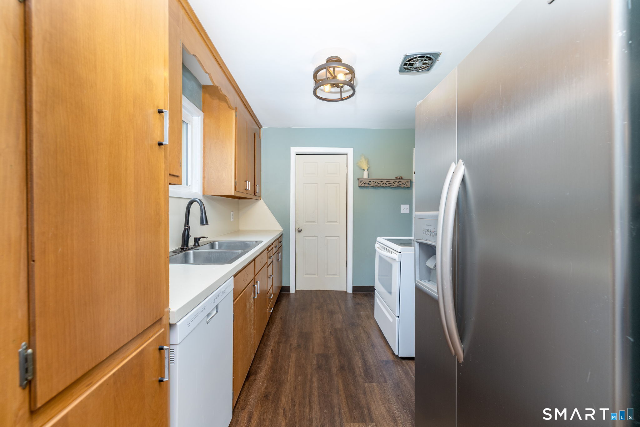 325 Barbara Road Middletown, CT 06457 - Photo 12 of 40 a kitchen with a refrigerator and a sink