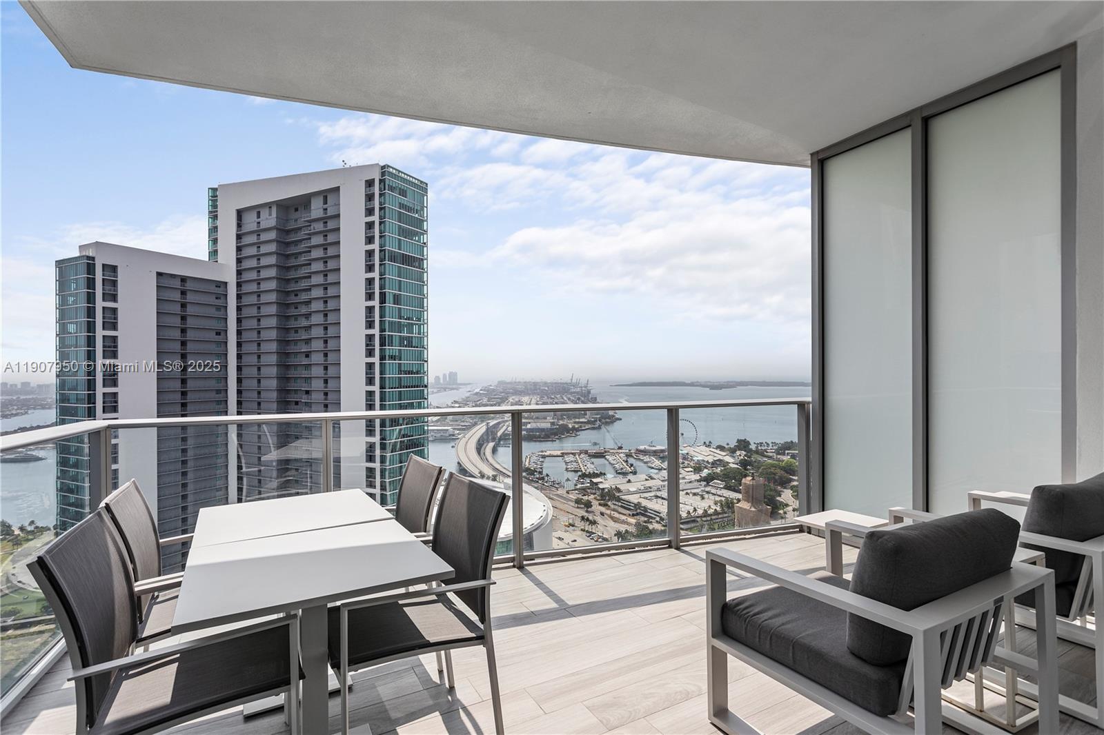 851 Northeast 1st Avenue, Unit 3907 Miami, FL 33132 - Photo 1 of 20 a balcony view with couple of chairs