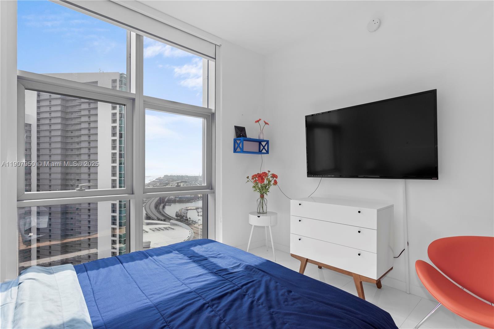 851 Northeast 1st Avenue, Unit 3907 Miami, FL 33132 - Photo 19 of 20 a living room with flat screen tv a rug and a window
