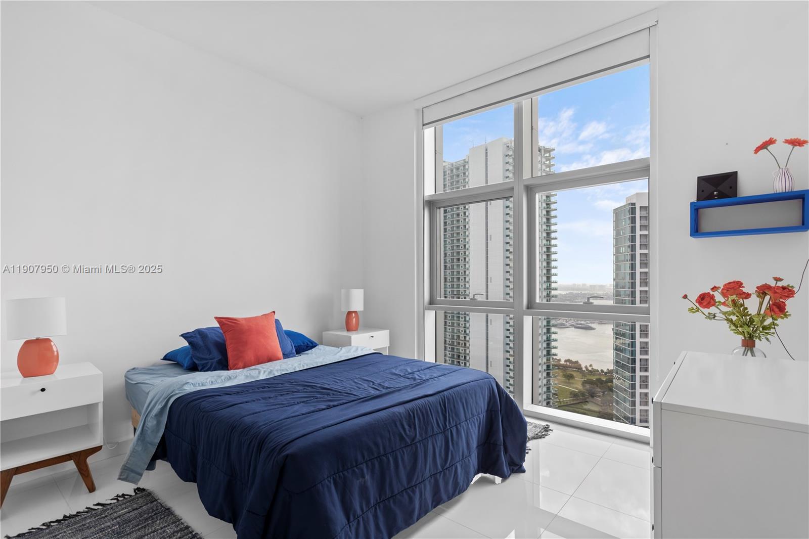 851 Northeast 1st Avenue, Unit 3907 Miami, FL 33132 - Photo 7 of 20 a bedroom with a bed and a window