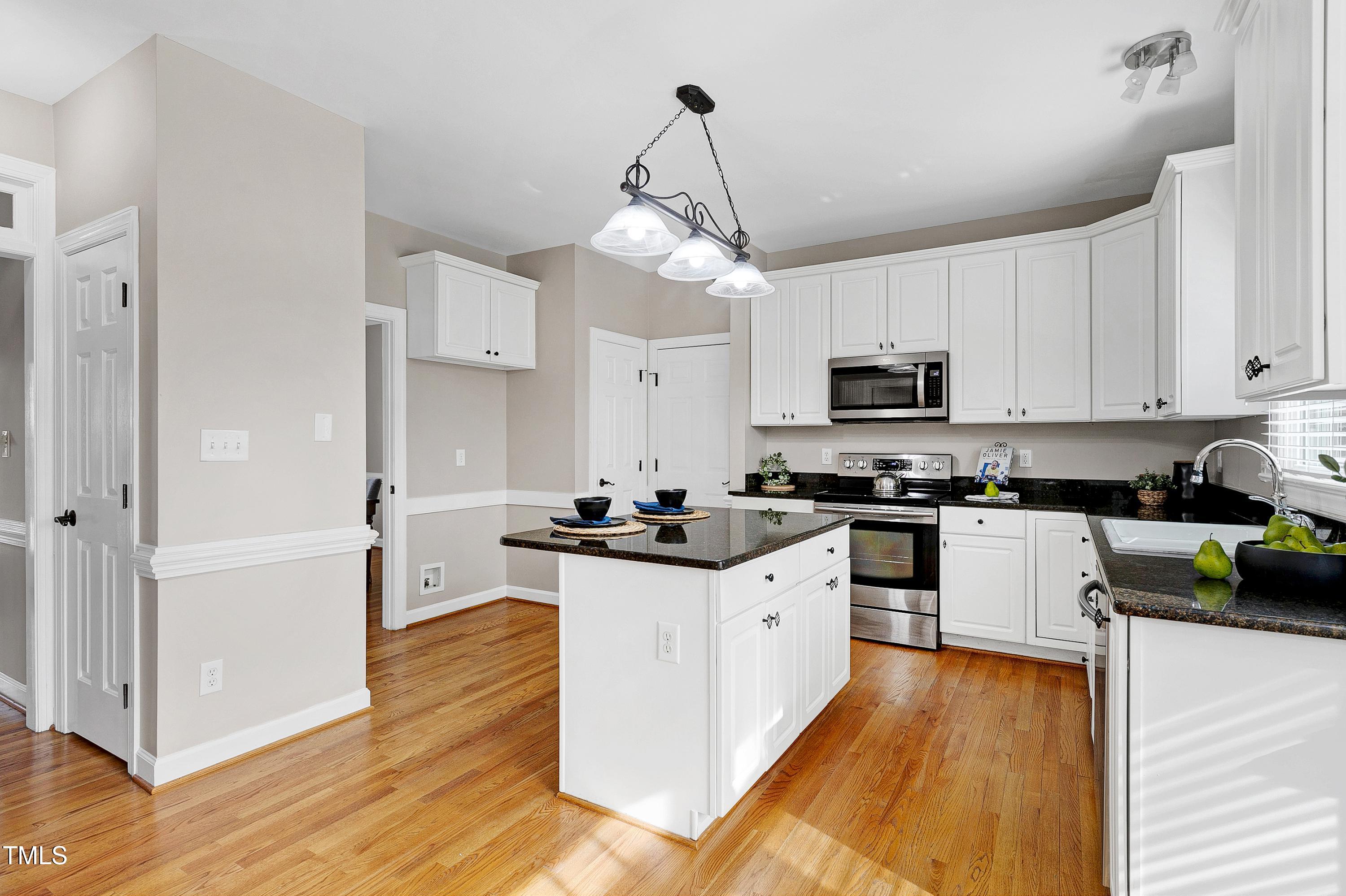 103 Sandy Hook Way Cary, NC 27513 - Photo 18 of 45 a kitchen with granite countertop a sink cabinets and stainless steel appliances