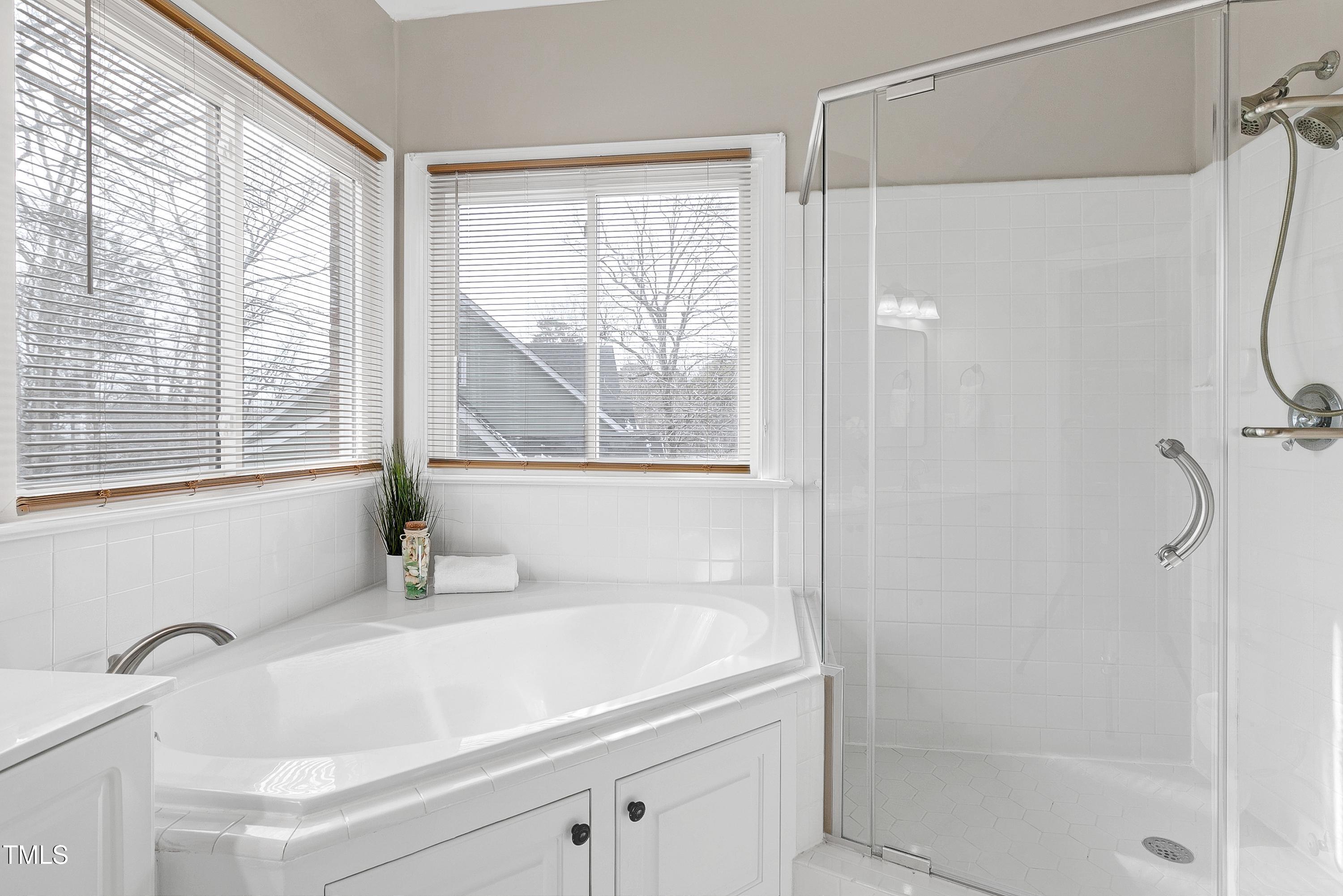 103 Sandy Hook Way Cary, NC 27513 - Photo 29 of 45 a bathroom with a tub and a shower