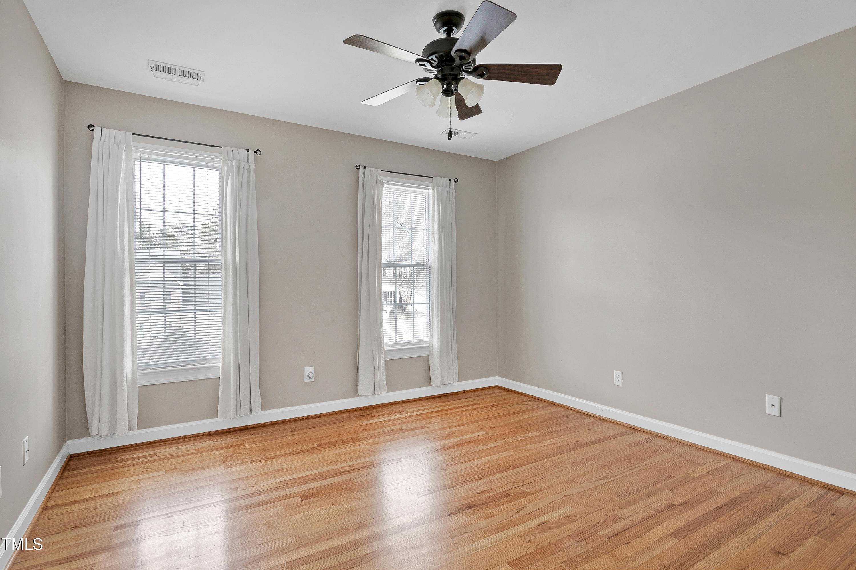 103 Sandy Hook Way Cary, NC 27513 - Photo 30 of 45 a view of empty room with wooden floor and fan