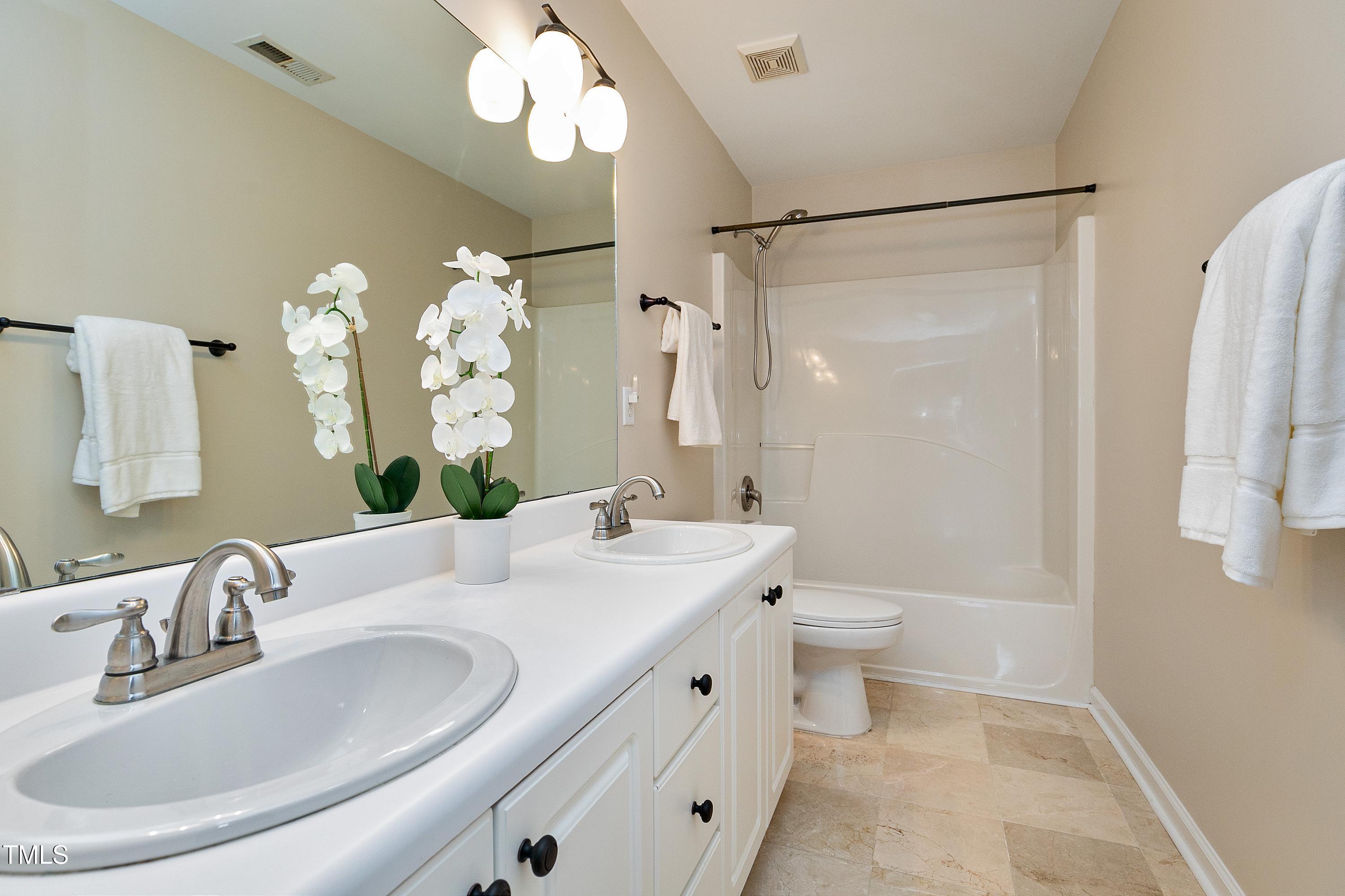 103 Sandy Hook Way Cary, NC 27513 - Photo 32 of 45 a bathroom with a double vanity sink mirror and toilet