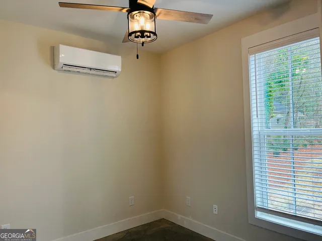 an entryway with wooden floor and cabinet