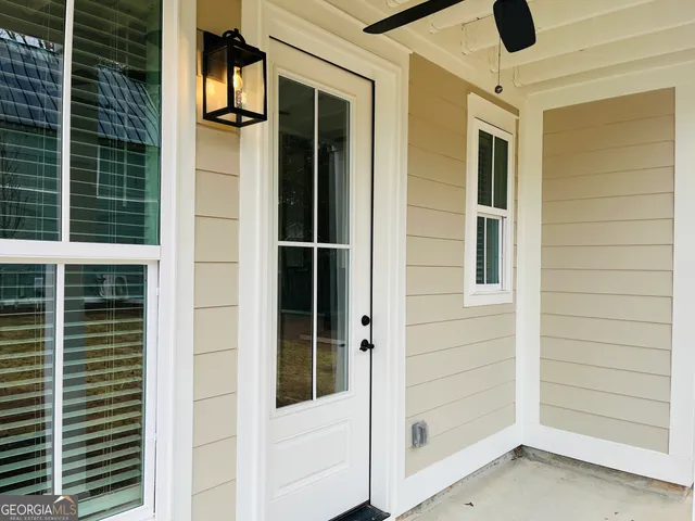 a view of front door and potted plants