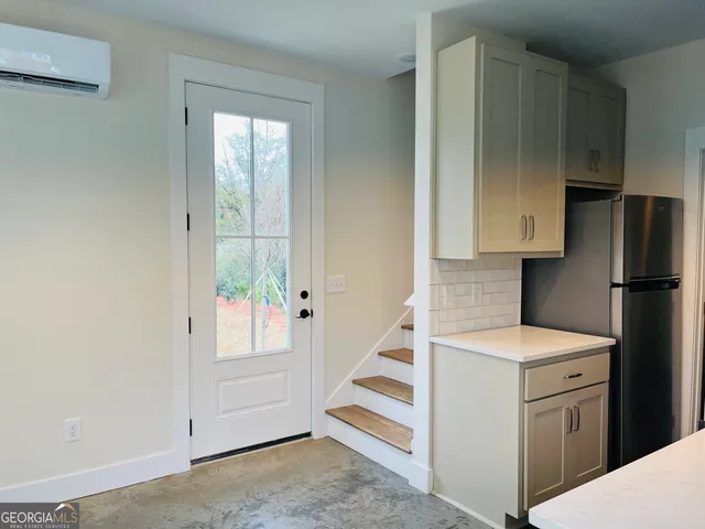 a utility room with cabinets washer and dryer