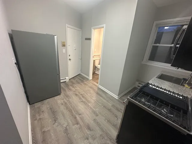 a view of an empty room and wooden floor