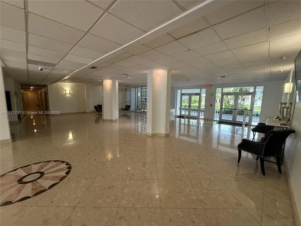 a lobby with furniture and floor to ceiling window