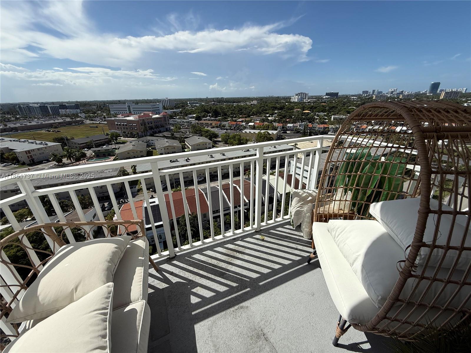 2100 Sans Souci Boulevard, Unit B1406 North Miami, FL 33181 - Photo 10 of 17 a view of a chairs and table on the terrace