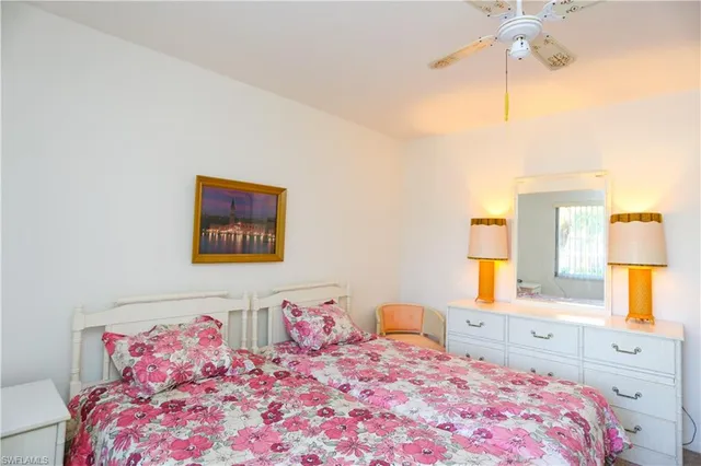 a bedroom with a bed and a lamp