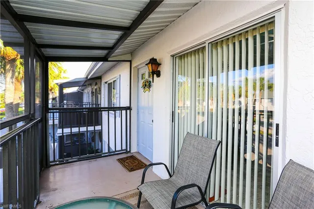 a balcony with table and chairs