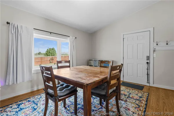 a view of a dining room with furniture and wooden floor
