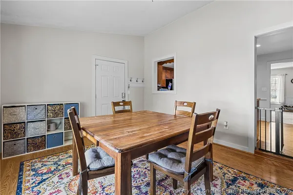 a view of a dining room with furniture and wooden floor