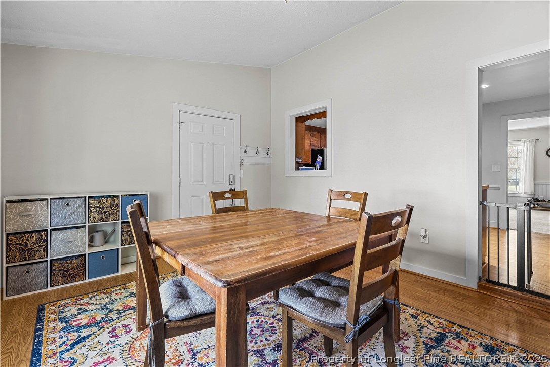 205 Violet Road Dunn, NC 28334 - Photo 13 of 31 a view of a dining room with furniture and wooden floor