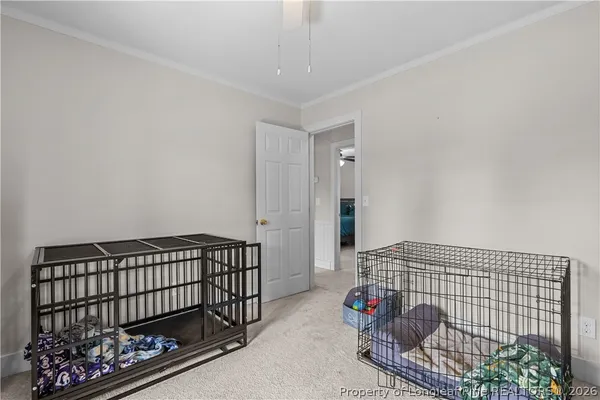 a bedroom with bed and a baby crib