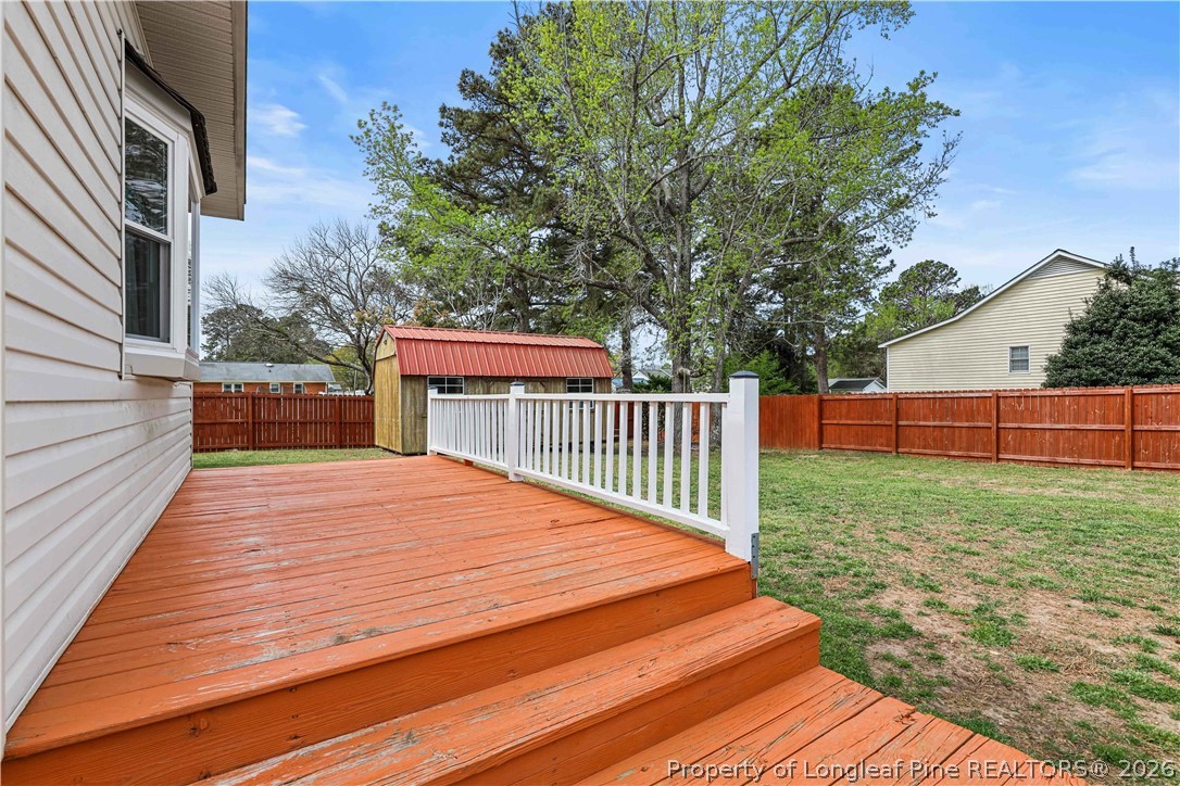 205 Violet Road Dunn, NC 28334 - Photo 24 of 31 a balcony with trees in front of it