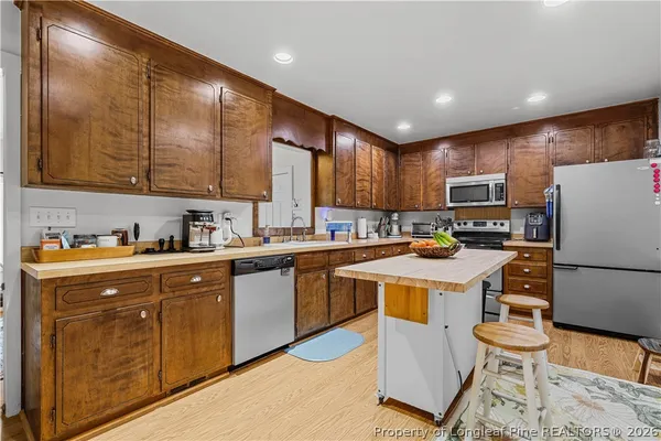 a kitchen with a cabinets a sink and white appliances