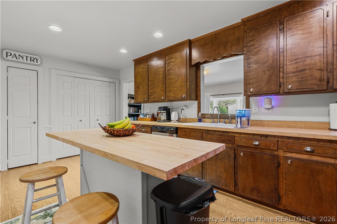 205 Violet Road Dunn, NC 28334 - Photo 9 of 31 a kitchen with a sink cabinets and wooden floor