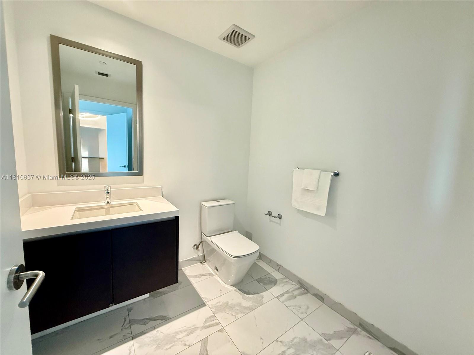 851 Northeast 1st Avenue, Unit 1108 Miami, FL 33132 - Photo 15 of 42 a bathroom with a sink and a mirror