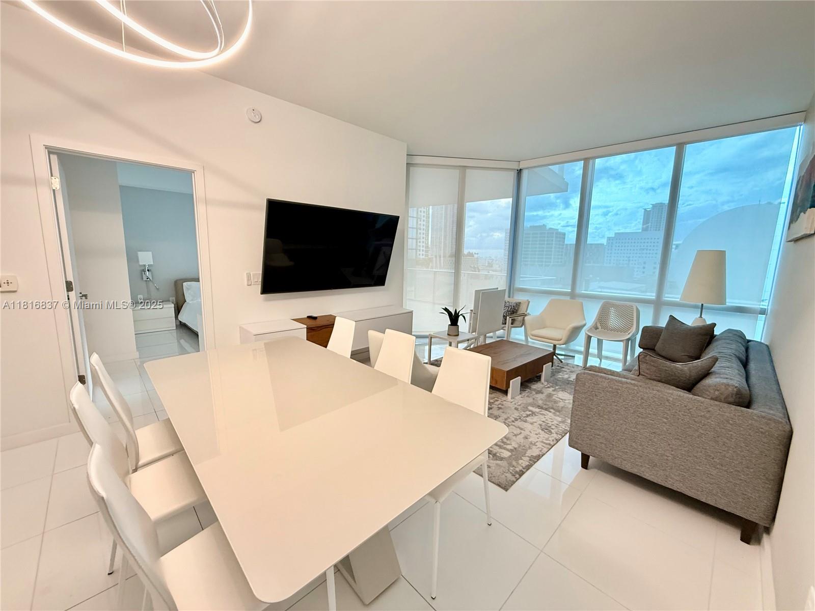 851 Northeast 1st Avenue, Unit 1108 Miami, FL 33132 - Photo 2 of 42 a living room with furniture and a flat screen tv