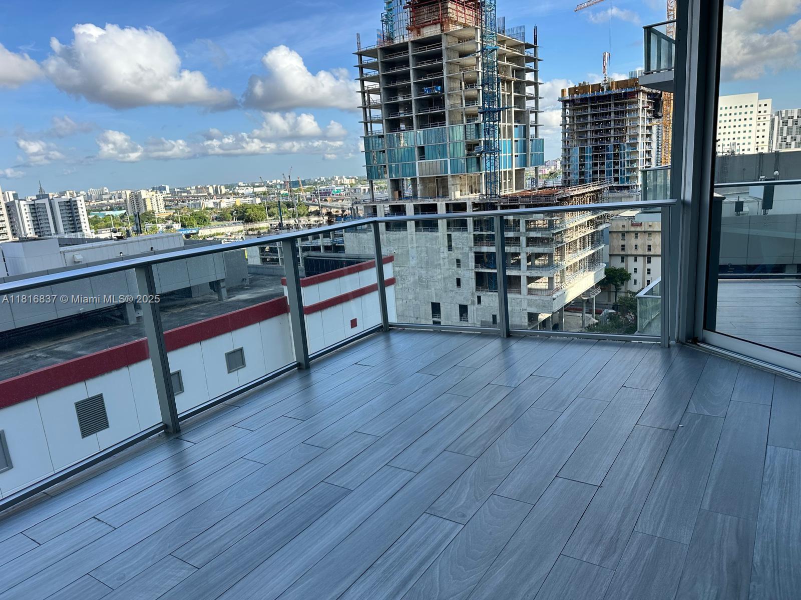 851 Northeast 1st Avenue, Unit 1108 Miami, FL 33132 - Photo 21 of 42 a view of a balcony with wooden floor
