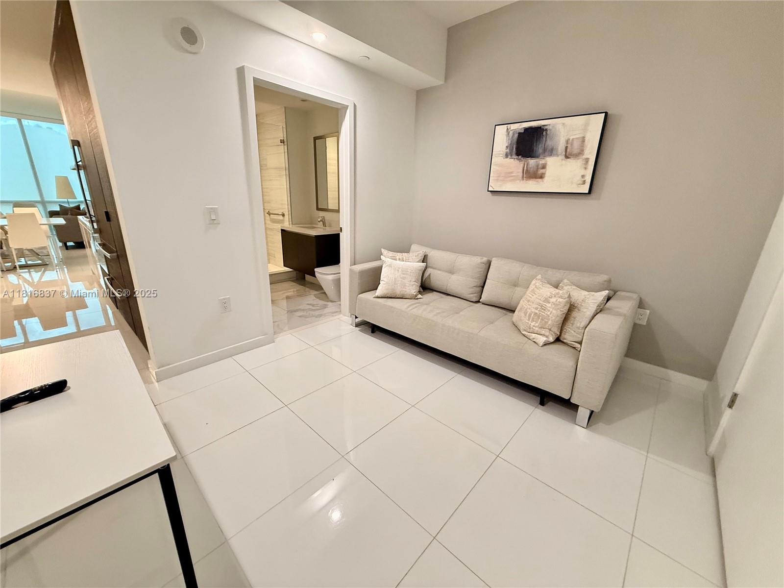 851 Northeast 1st Avenue, Unit 1108 Miami, FL 33132 - Photo 9 of 42 a living room with furniture and a baby crib