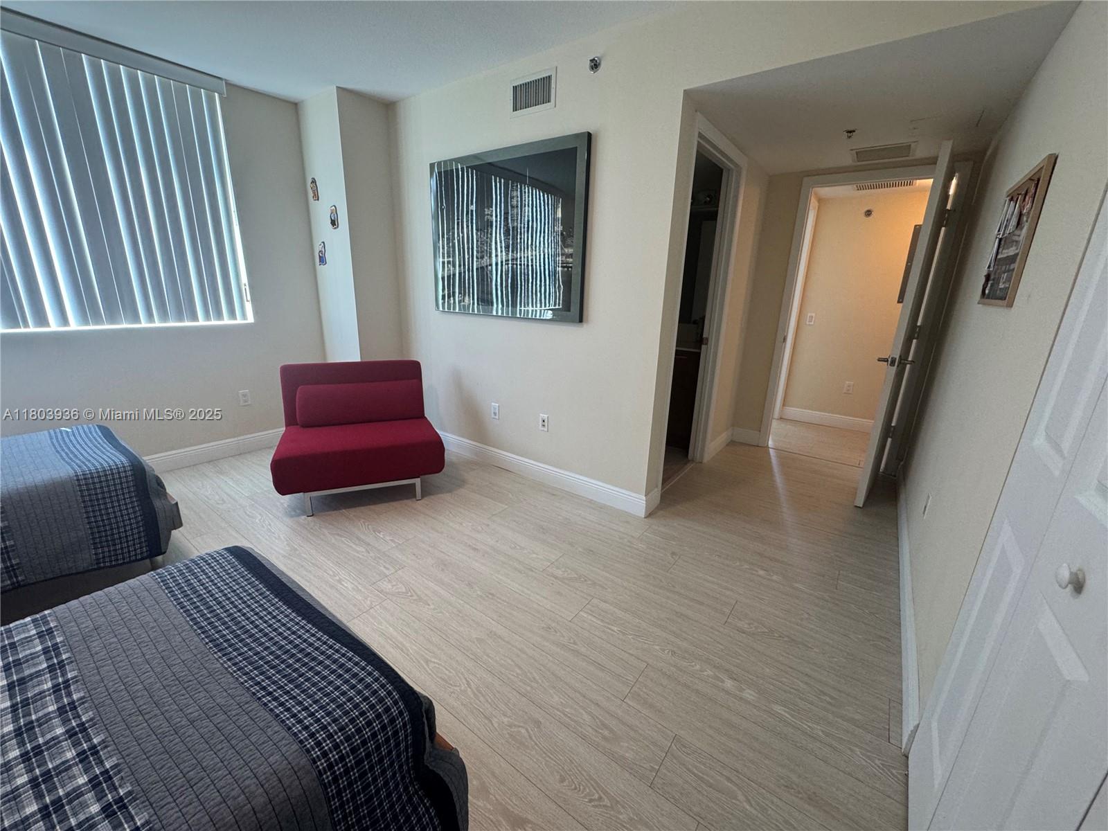 2641 North Flamingo Road, Unit 1001N Sunrise, FL 33323 - Photo 43 of 84 a bedroom with a bed and a couch