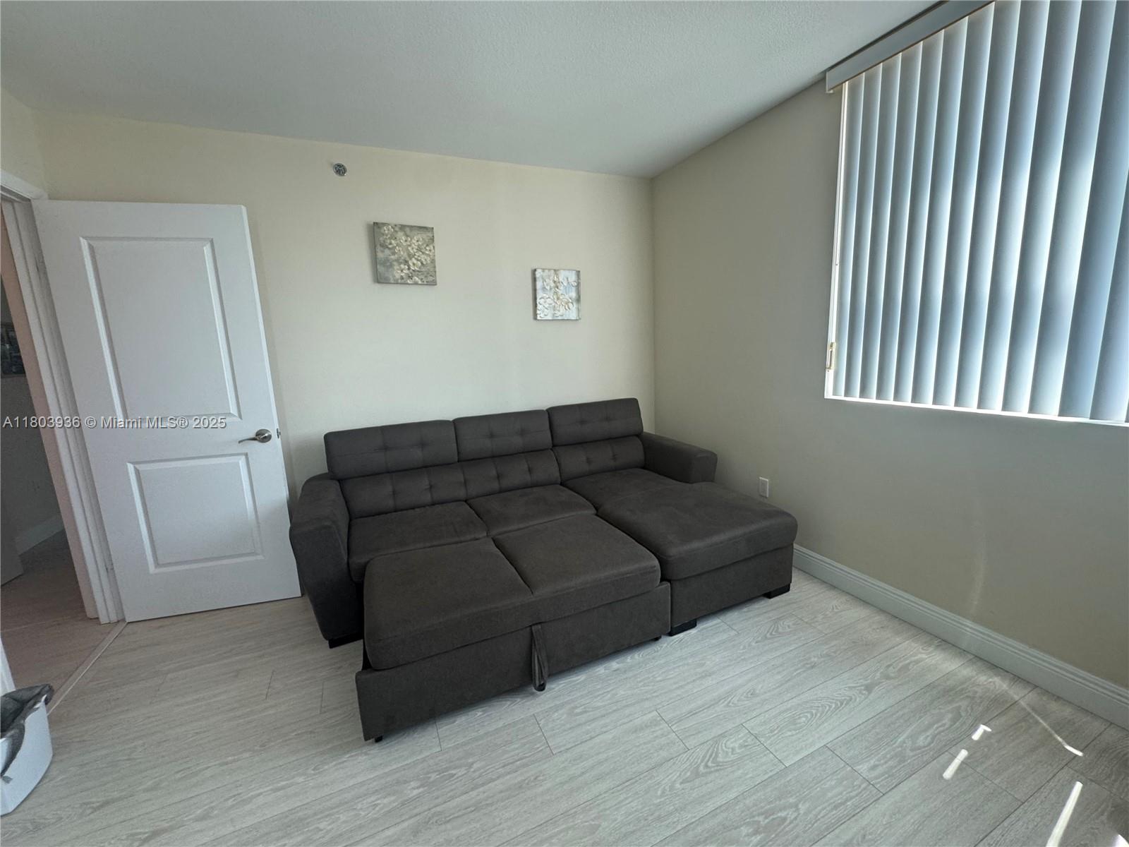 2641 North Flamingo Road, Unit 1001N Sunrise, FL 33323 - Photo 50 of 84 a living room with a couch and a window