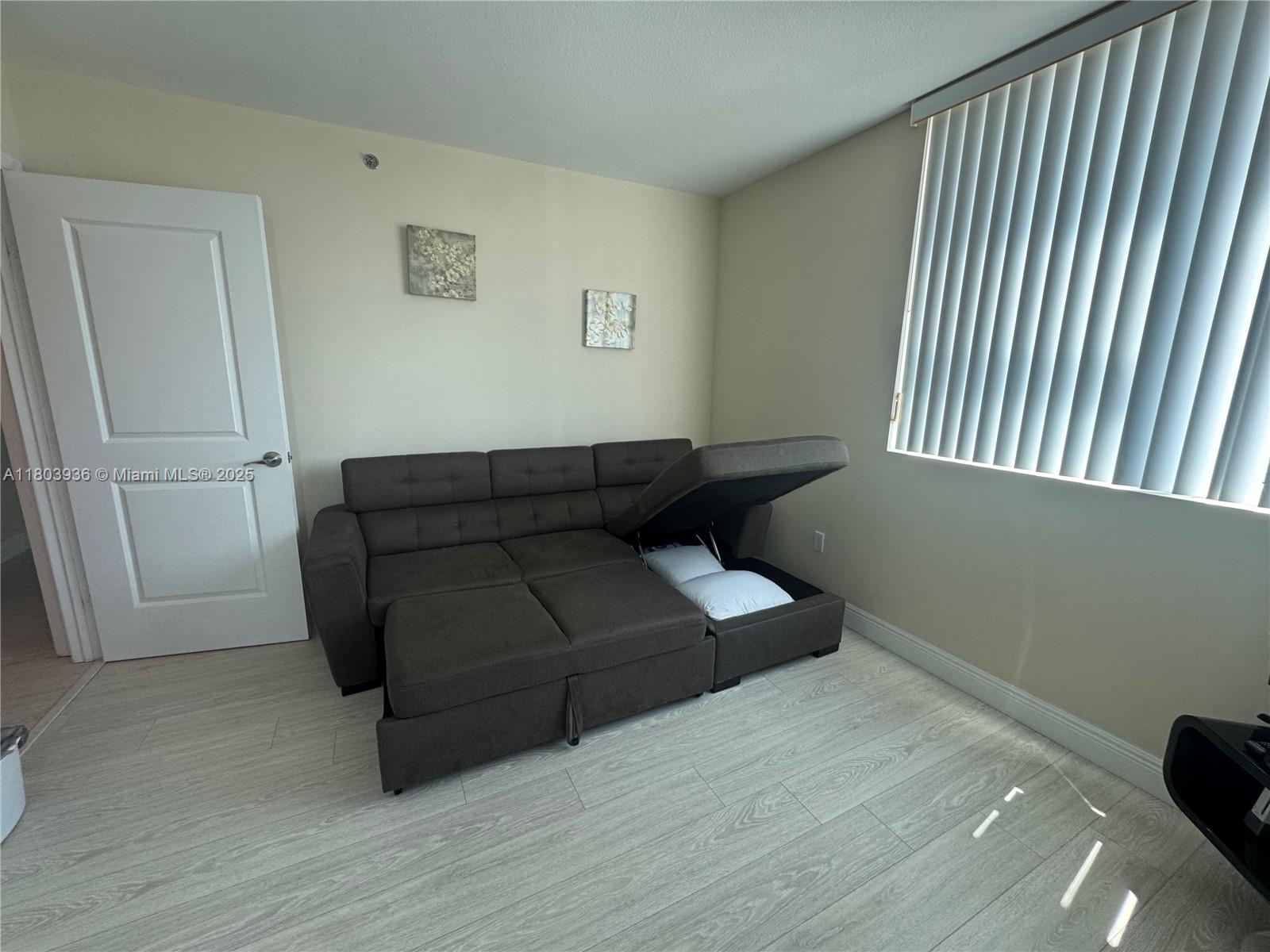 2641 North Flamingo Road, Unit 1001N Sunrise, FL 33323 - Photo 51 of 84 a living room with furniture and a wooden floor