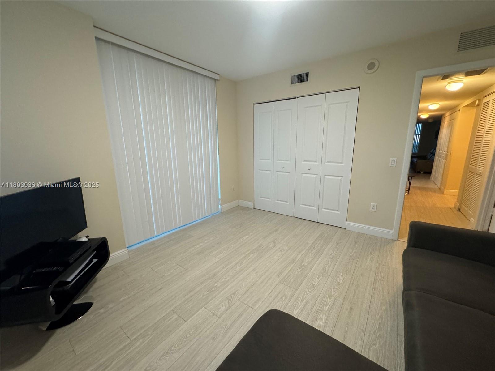 2641 North Flamingo Road, Unit 1001N Sunrise, FL 33323 - Photo 52 of 84 a view of room with furniture and wooden floor