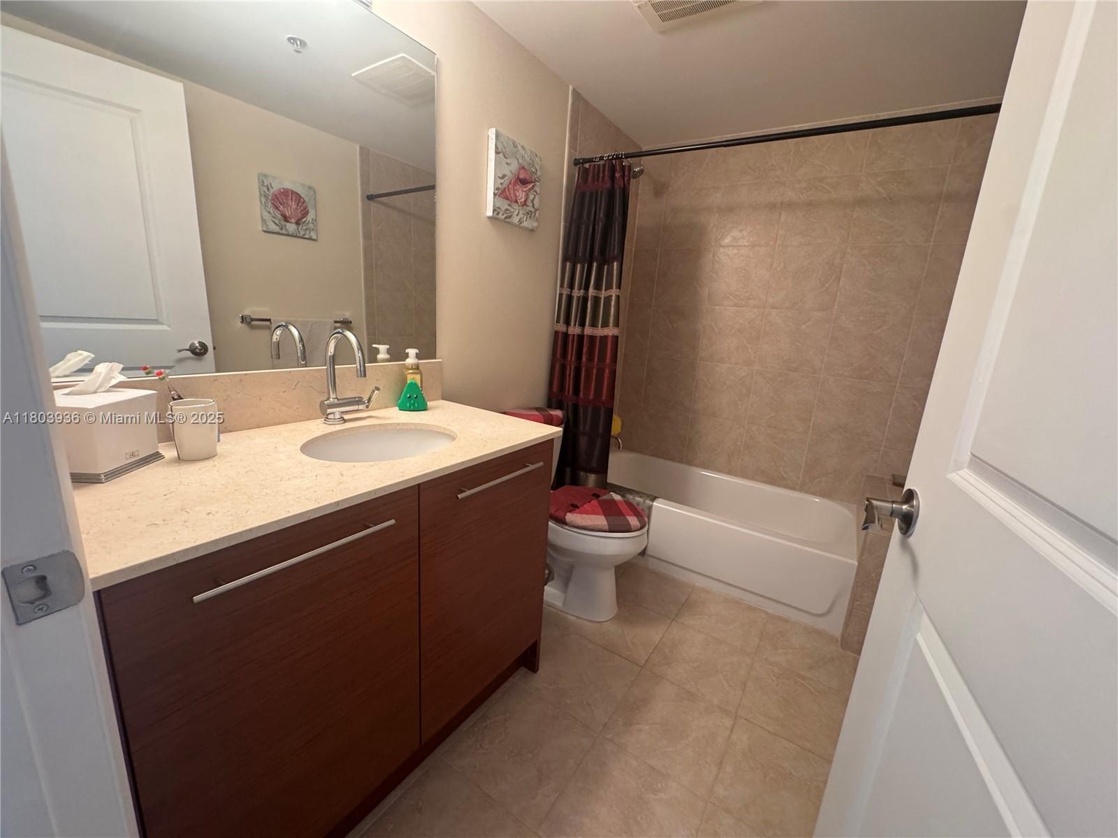 2641 North Flamingo Road, Unit 1001N Sunrise, FL 33323 - Photo 59 of 84 a bathroom with a sink a toilet a mirror and shower