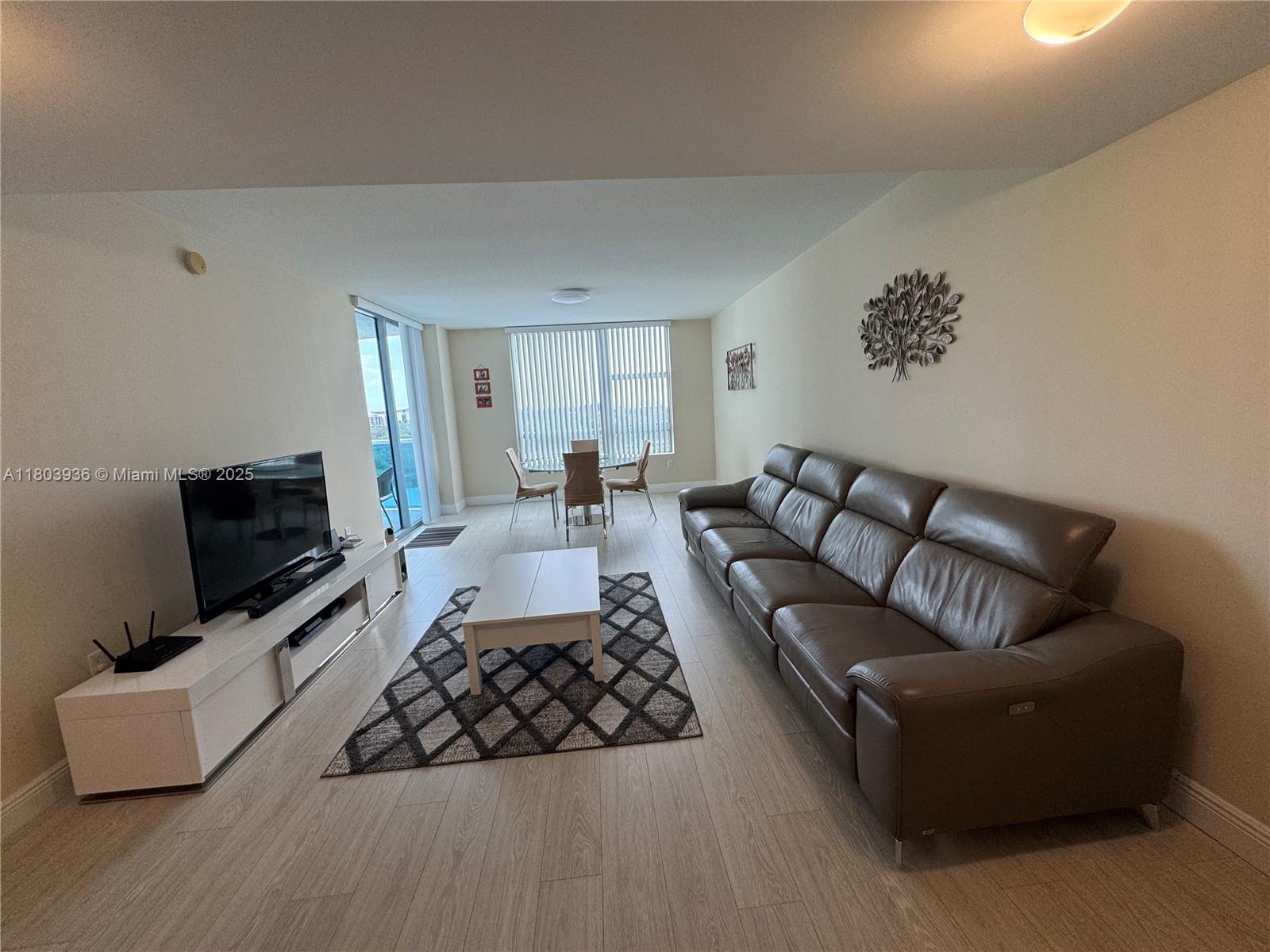 2641 North Flamingo Road, Unit 1001N Sunrise, FL 33323 - Photo 62 of 84 a living room with furniture and a flat screen tv