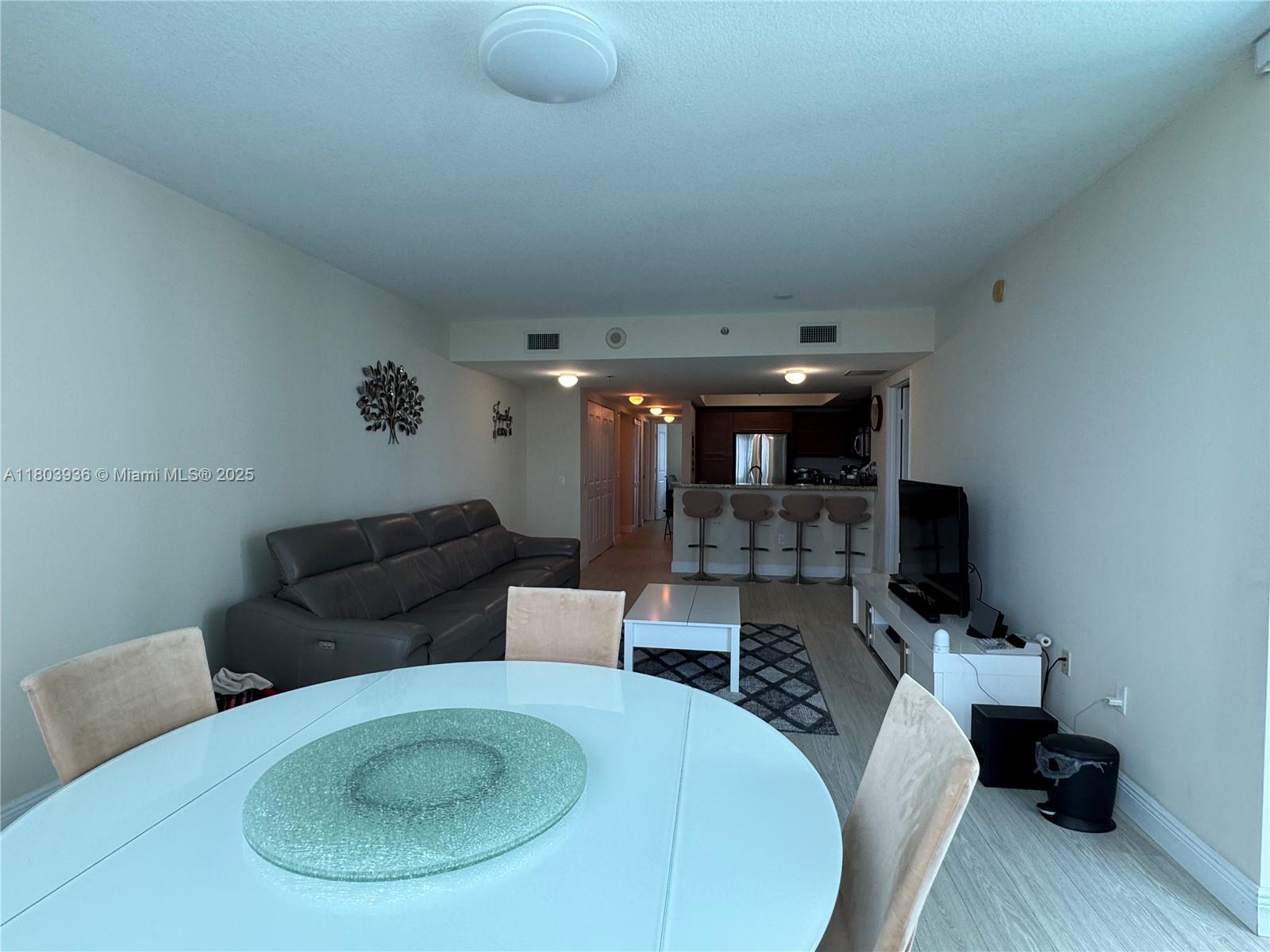 2641 North Flamingo Road, Unit 1001N Sunrise, FL 33323 - Photo 64 of 84 a living room with furniture and a flat screen tv