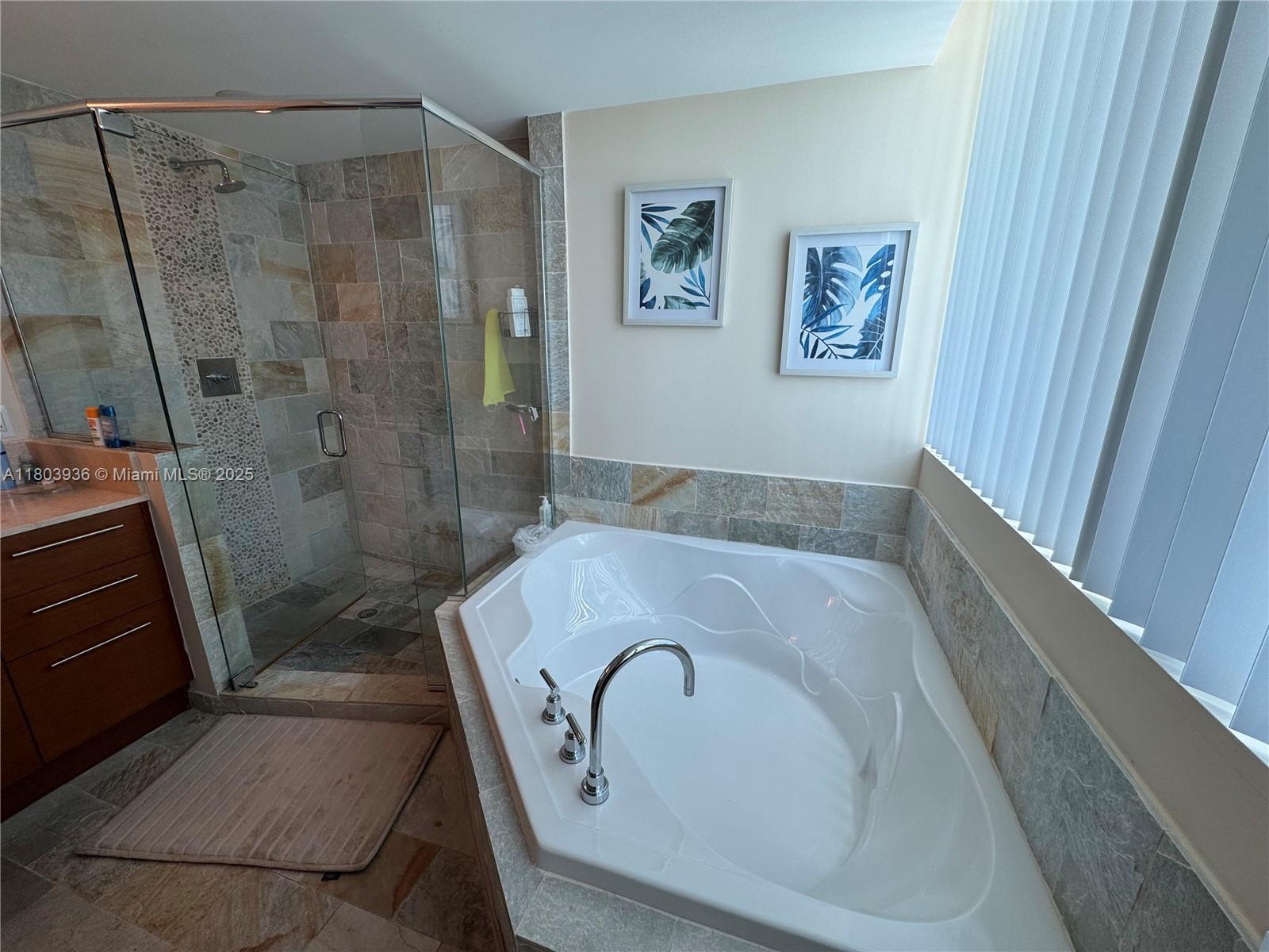 2641 North Flamingo Road, Unit 1001N Sunrise, FL 33323 - Photo 73 of 84 a bathroom with a tub and a shower