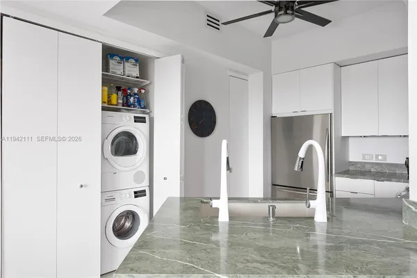 a view of kitchen and living room with washer and dryer