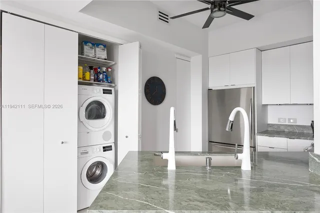 a view of kitchen and living room with washer and dryer