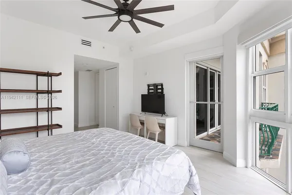 a bedroom with a bed and a flat screen tv