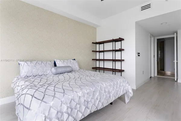 a bedroom with a bed and a window