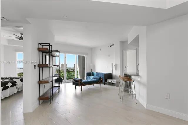 a living room with furniture and a large window