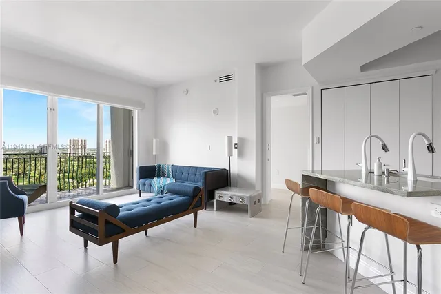 a living room with furniture and a large window