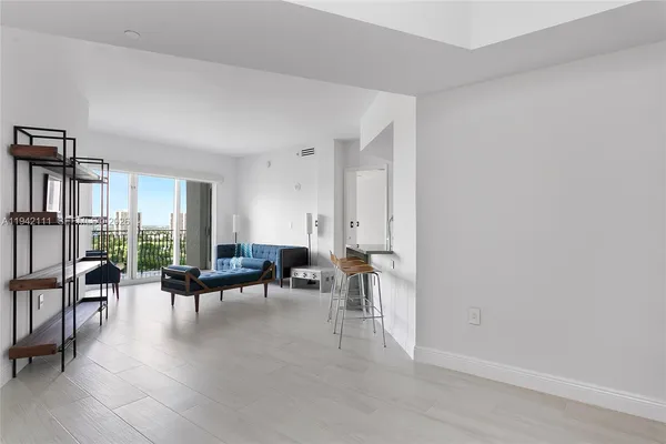 a living room with furniture and large windows