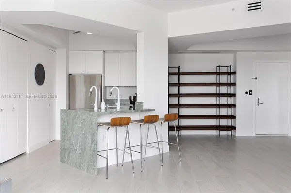 a view of entryway and kitchen