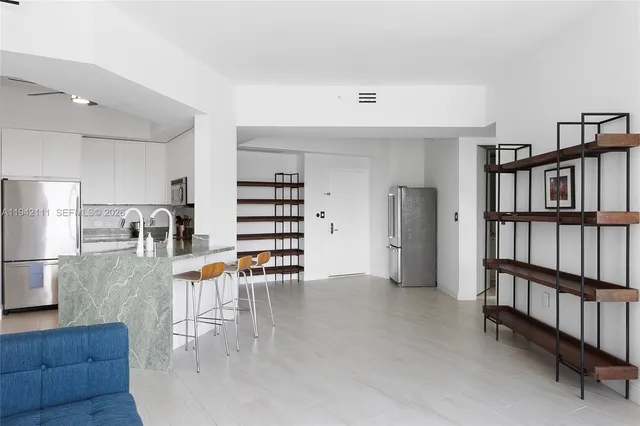 a view of a kitchen with dining room and wooden floor