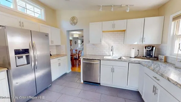 a kitchen with granite countertop stainless steel appliances cabinets and a sink